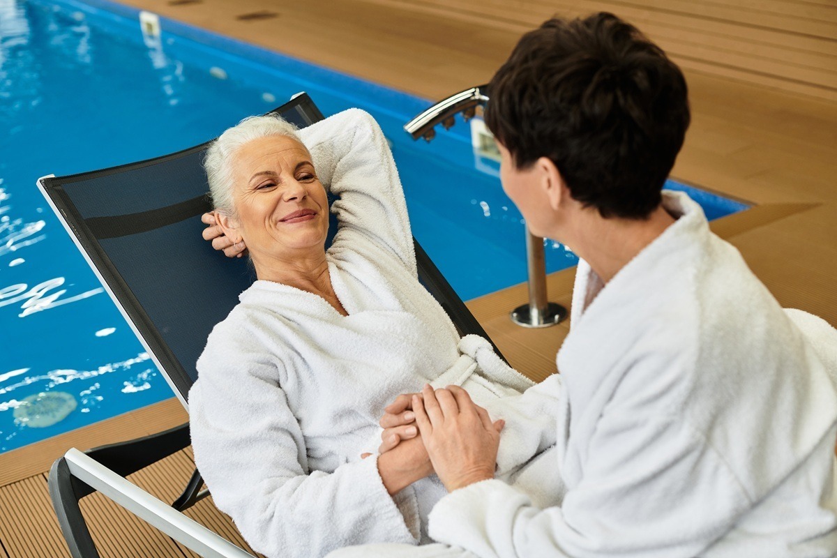 Two mature women enjoying wellness activities at a serene spa