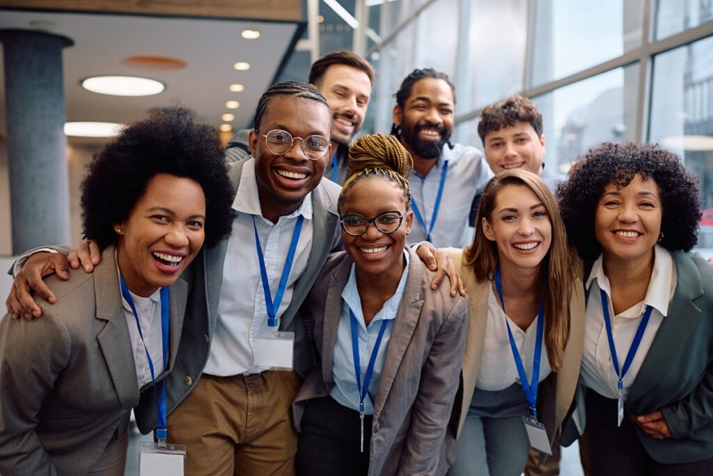 Group of happy business people attending an education event and looking at camera.