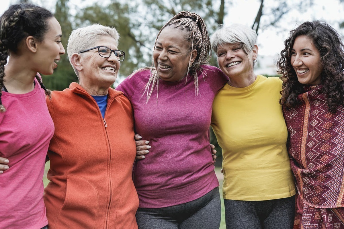 Group of women outside smiling.
