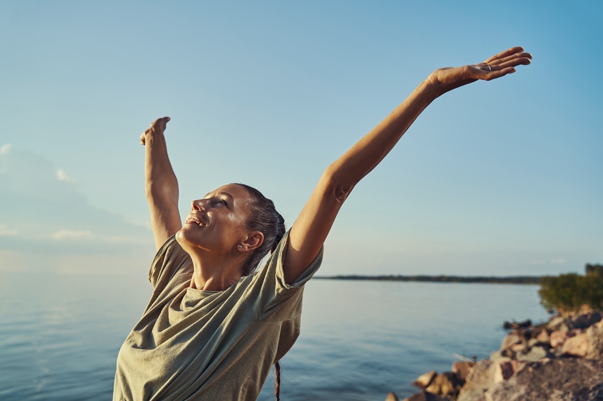 Woman raising hands up and feeling free. Woman raising hands up and feeling free
