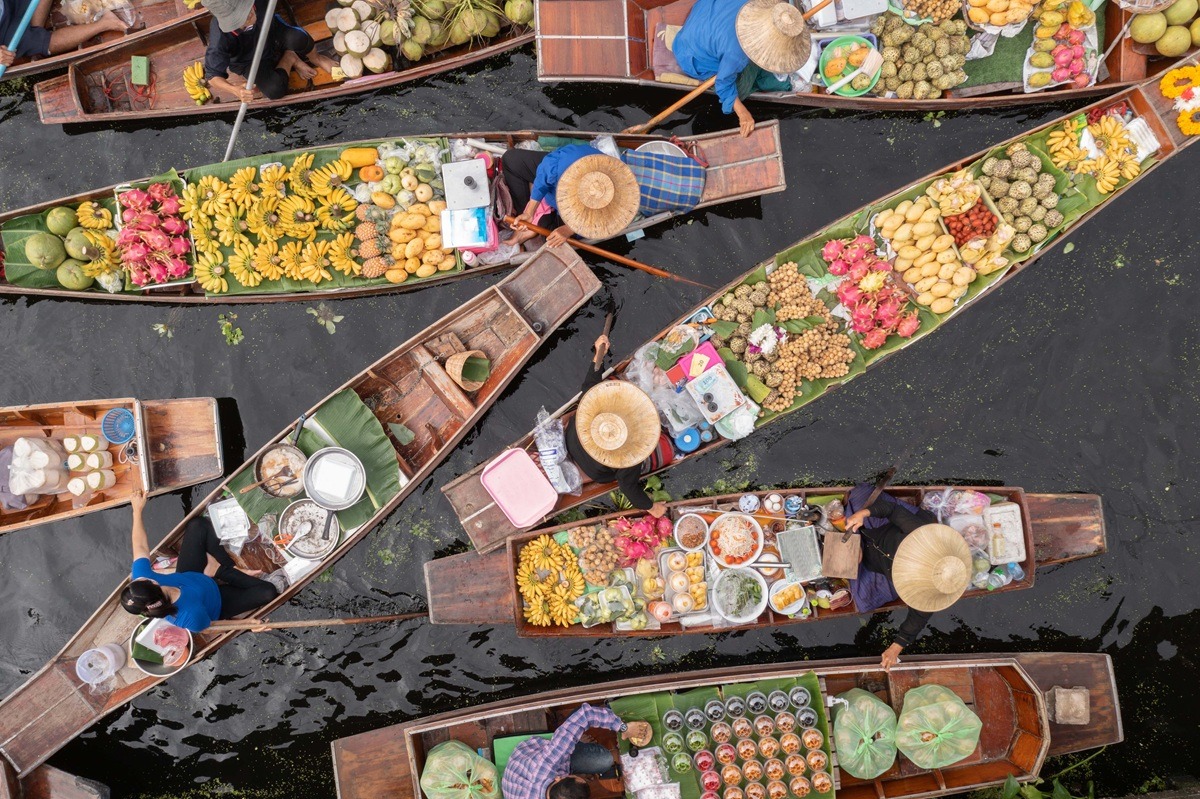 Ayutthaya Bangkok Thailand traditional holiday floating market visitor shop on river selling farmer food and fruit vegetable colorful flowers and clothes on the wooden boat. Ayutthaya Bangkok Thailand traditional holiday floating market visitor shop on river selling farmer food and fruit vegetable colorful flowers and clothes on the wooden boat.