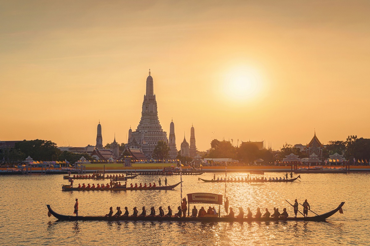 The Temple of Dawn, Wat Arun, with the royal barge procession for The Thai King on Chao Phraya River near Downtown of Bangkok City, Thailand. The Temple of Dawn, Wat Arun, with the royal barge procession for The Thai King on Chao Phraya River near Downtown of Bangkok City, Thailand.
