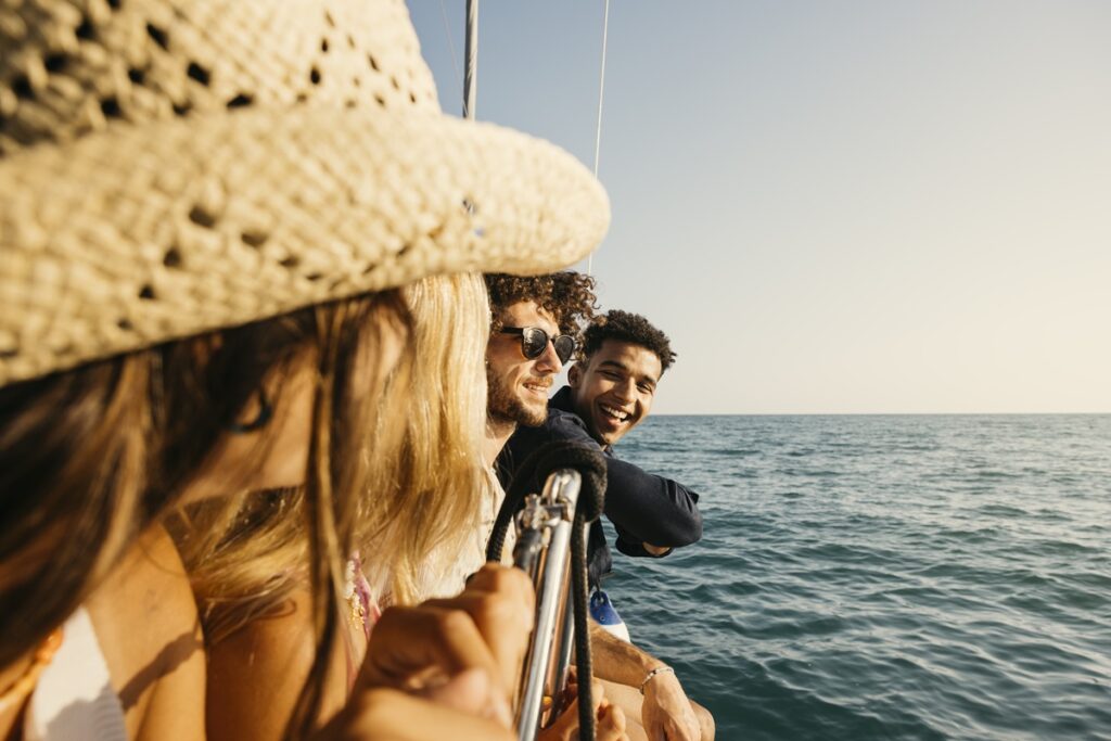 Group of friends enjoying a relaxing sailboat ride on a sunny summer day
