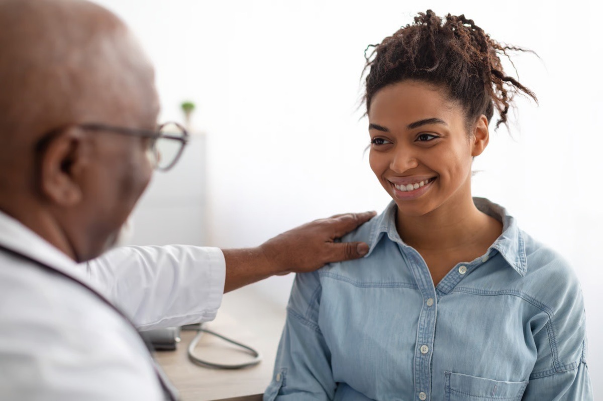 A doctor reassuring a patient during a consultation.