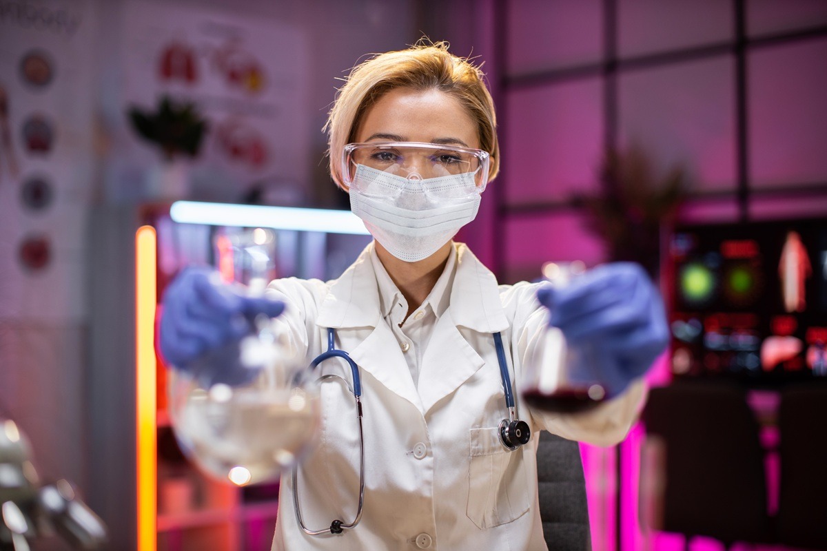 Female scientist testing experiment in a science lab where she holding scientific test tube full of chemical substance. Female scientist testing experiment in a science lab where she holding scientific test tube full of chemical substance.