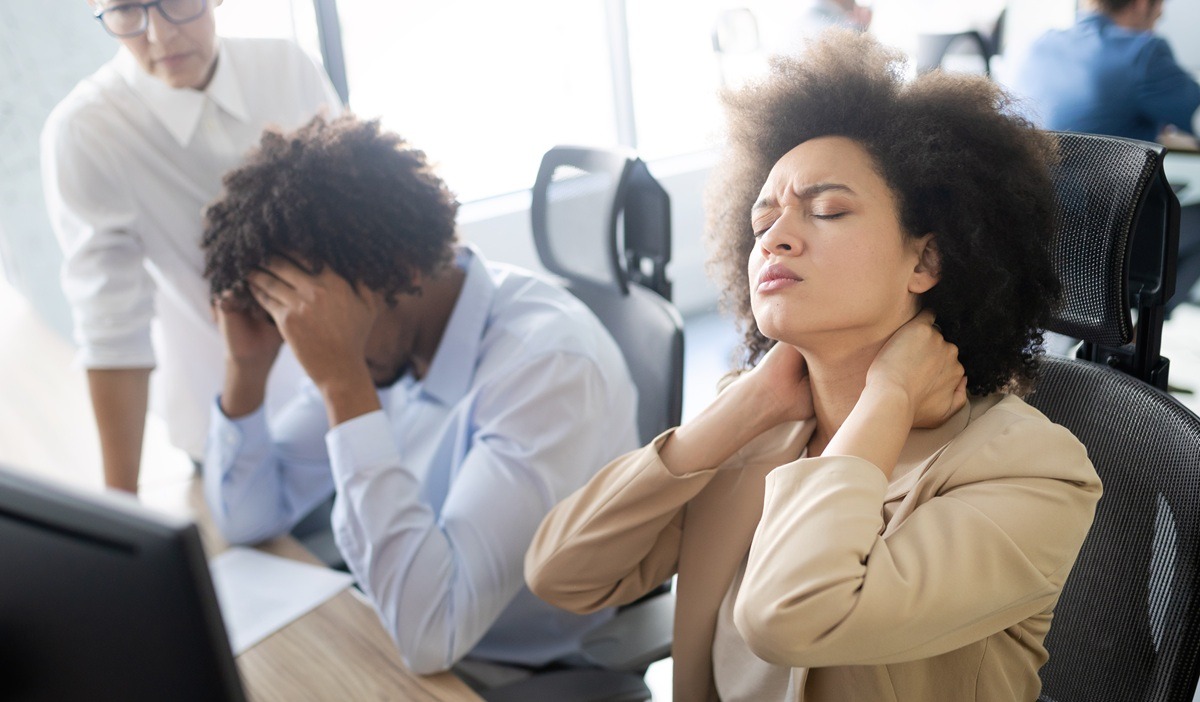 Young woman and man having stress and pain in the office.