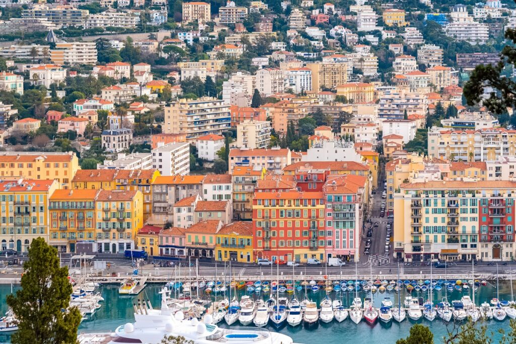 Nice in France, the harbor, old colorful buildings on the quays and boats in the marina A Slow Wellness Day in Nice, on Foot. This is Nice; the harbour, the vibrant buildings, the historic ambience, the culturally rich, and the ineffable beauty.