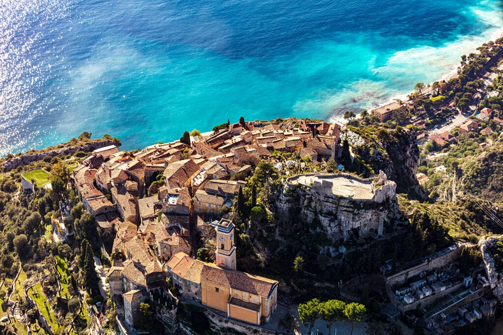 The small town of Eze perched on a hill, offering a stunning vista of the ocean below and surrounding landscape.
