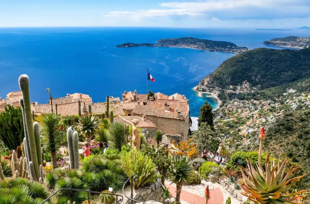 Eze, the picturesque small town on a hill, with charming buildings overlooking a serene ocean view. 
