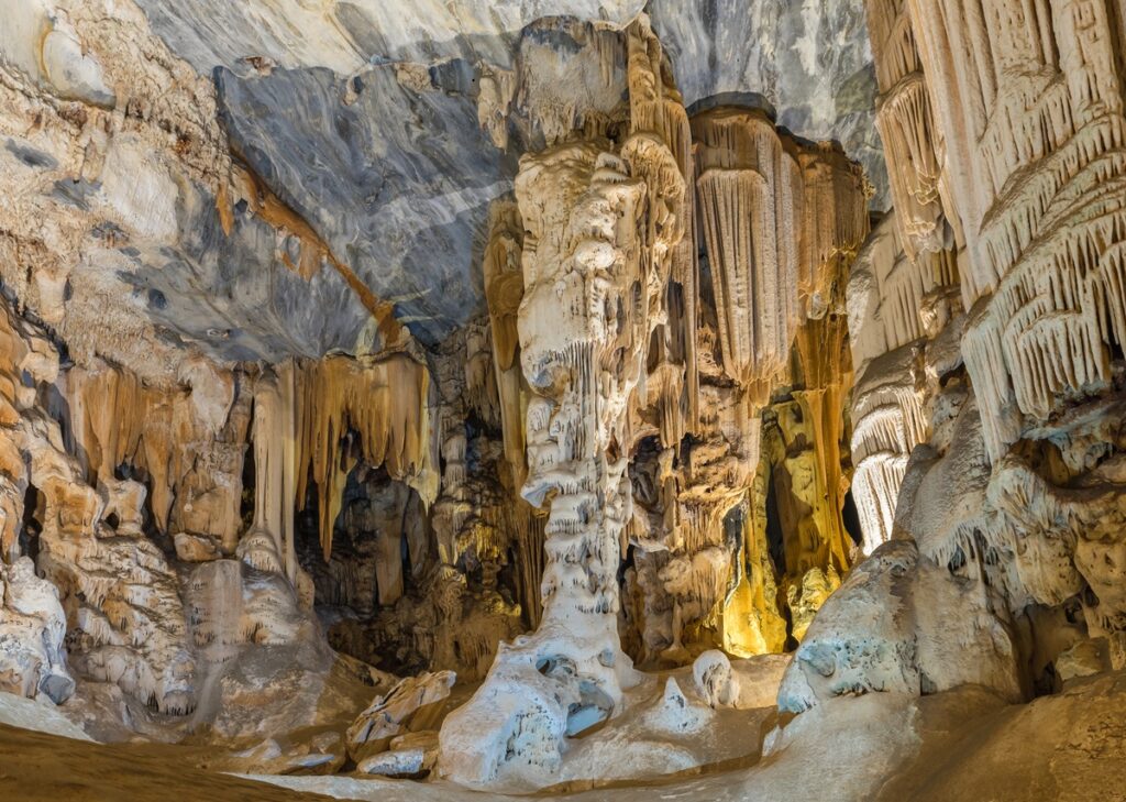 Interior view of a cave featuring numerous tall rock formations and natural structures. This is what Monaco's Observatory Cave looks like. Interior view of a cave featuring numerous tall rock formations and natural structures.