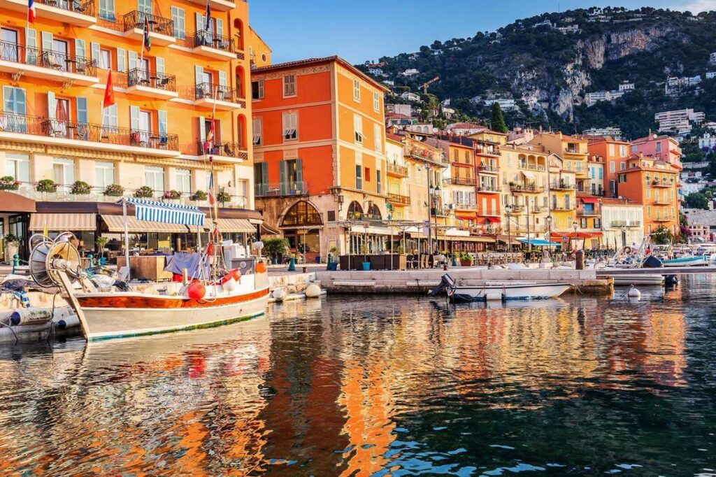 The vibrant, natural harbour of Villefranche, featuring colorful buildings and various boats docked along the waterfront. A vibrant harbour in France, featuring colorful buildings and various boats docked along the waterfront.