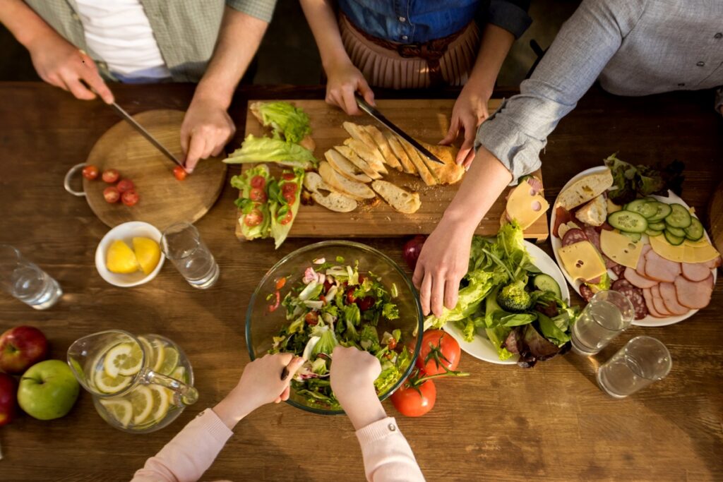 Cropped shot of family preparing homemade dinner together as part of the Mediterranean lifestyle.