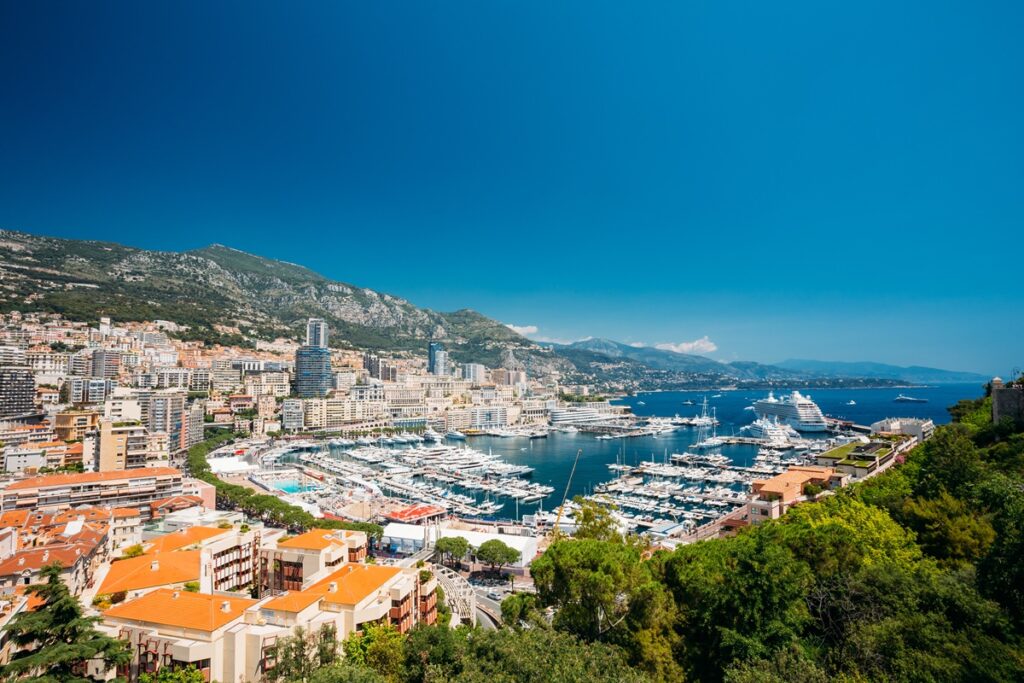 A panoramic view of Monaco showcasing its iconic skyline, luxury buildings, and the Mediterranean coastline. A panoramic view of Monaco showcasing its iconic skyline, luxury buildings, and the Mediterranean coastline.